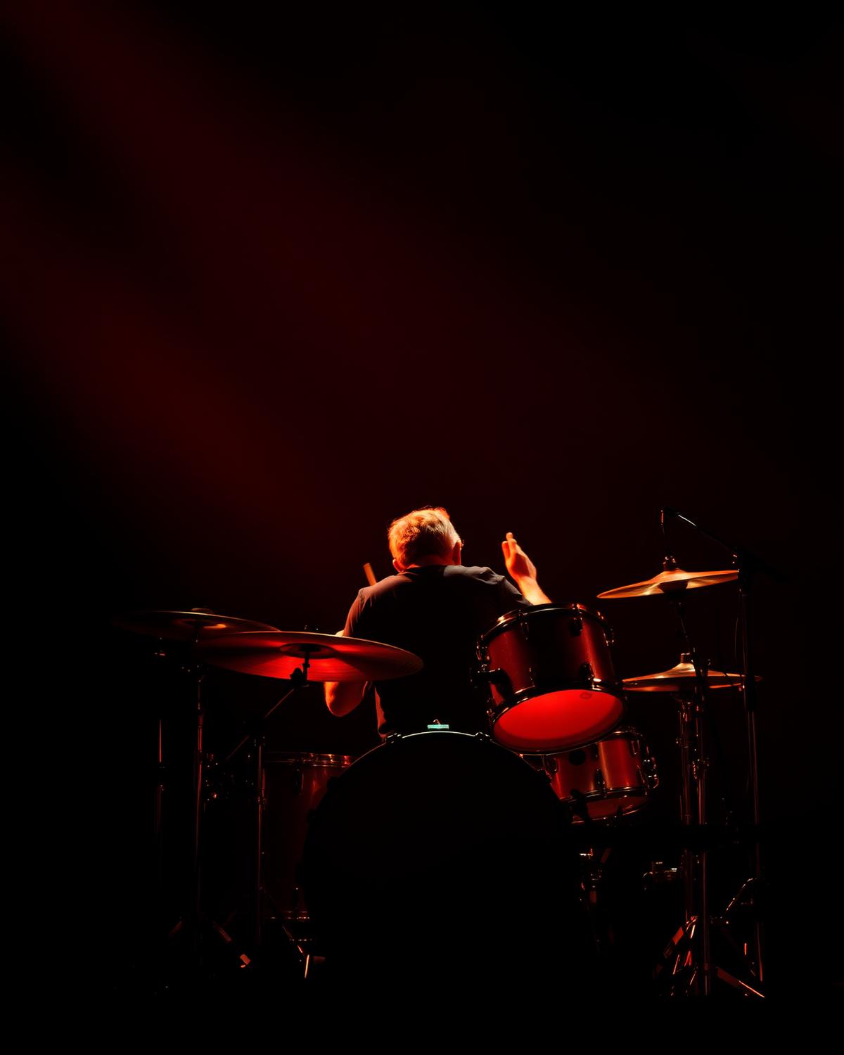 Drummer in red stage light